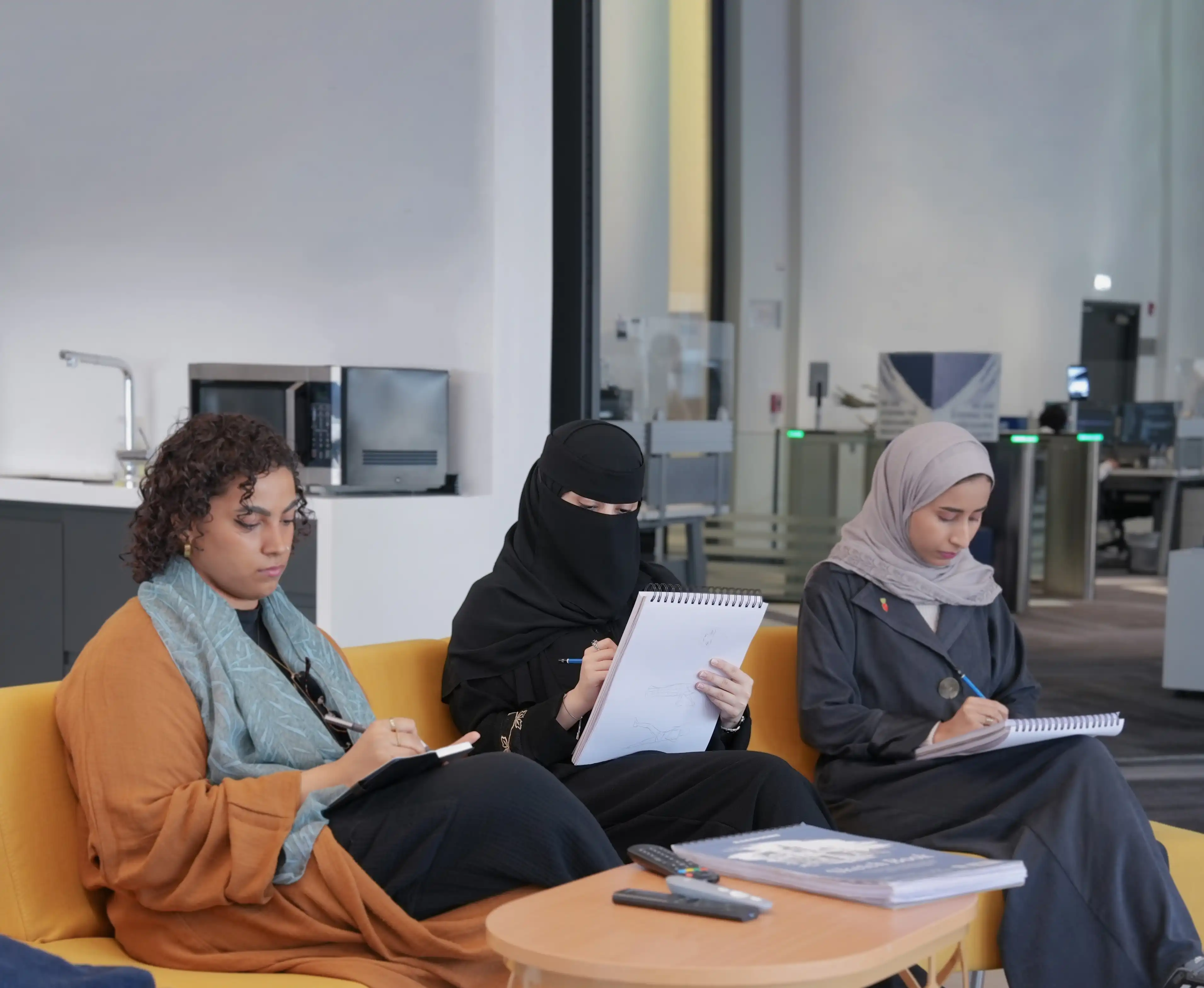 three staff members at steer studios sitting comfortably and sketching ideas
